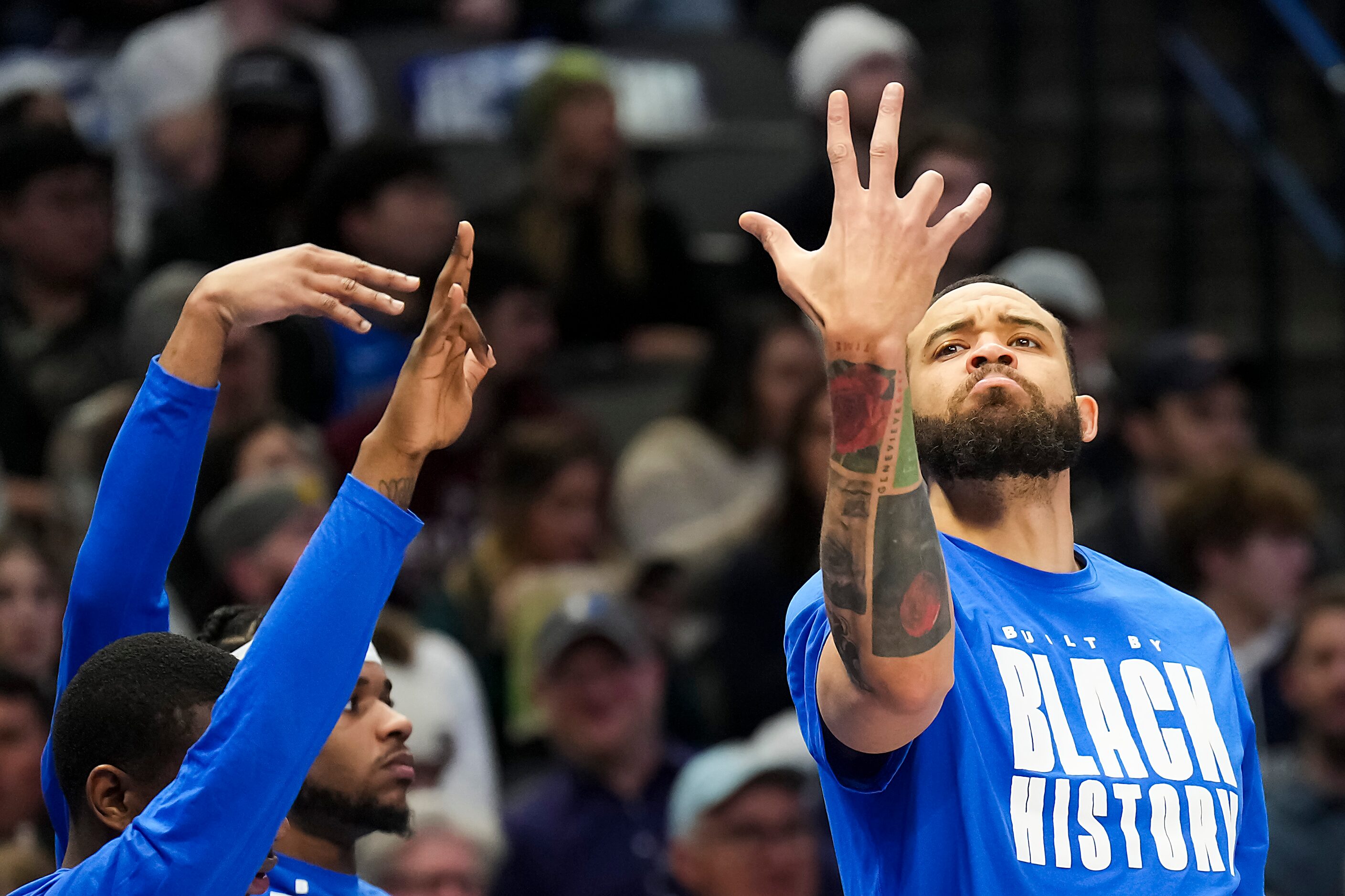 Dallas Mavericks center JaVale McGee celebrates a 3-pointer by forward Davis Bertans during...