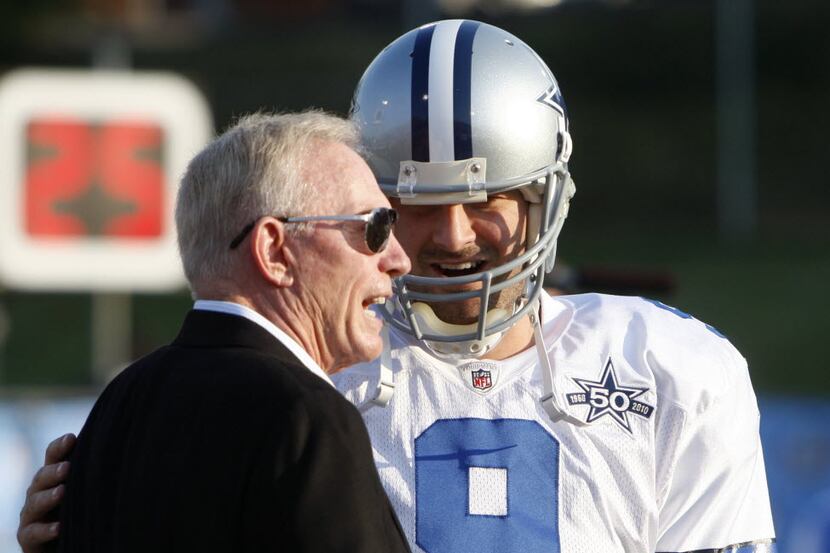 Dallas Cowboys Tony Romo talks with owner Jerry Jones before the start of a game against the...
