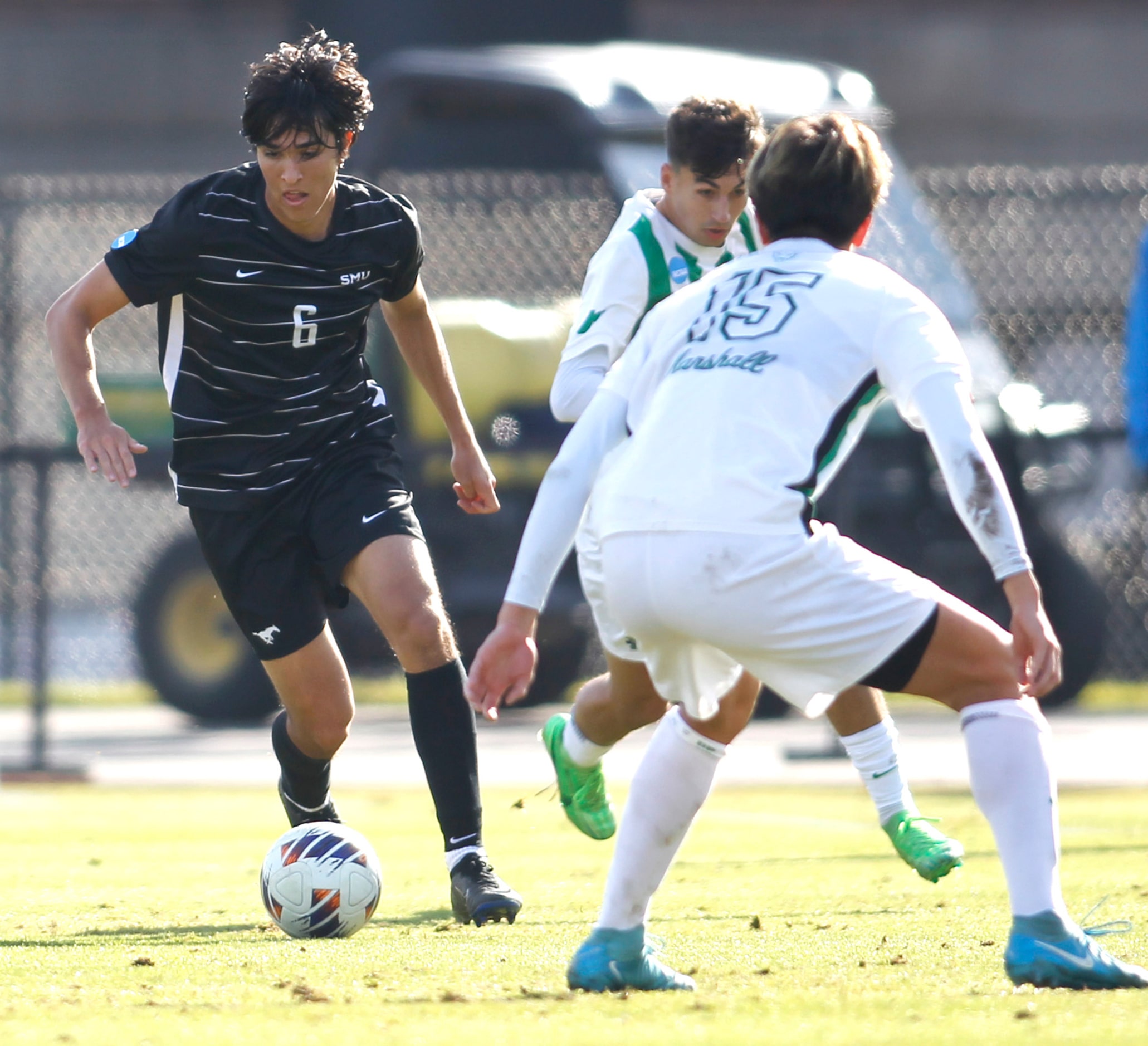 SMU midfielder Alex Salvo (6), left, controls the ball around the defense of Marshall...