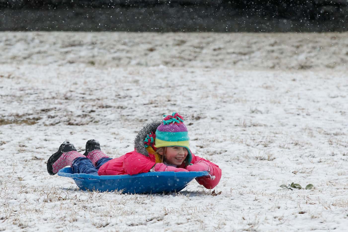 Kids enjoy a white Christmas by sledding at Flag Pole Hill Park in Dallas on Tuesday, Dec....