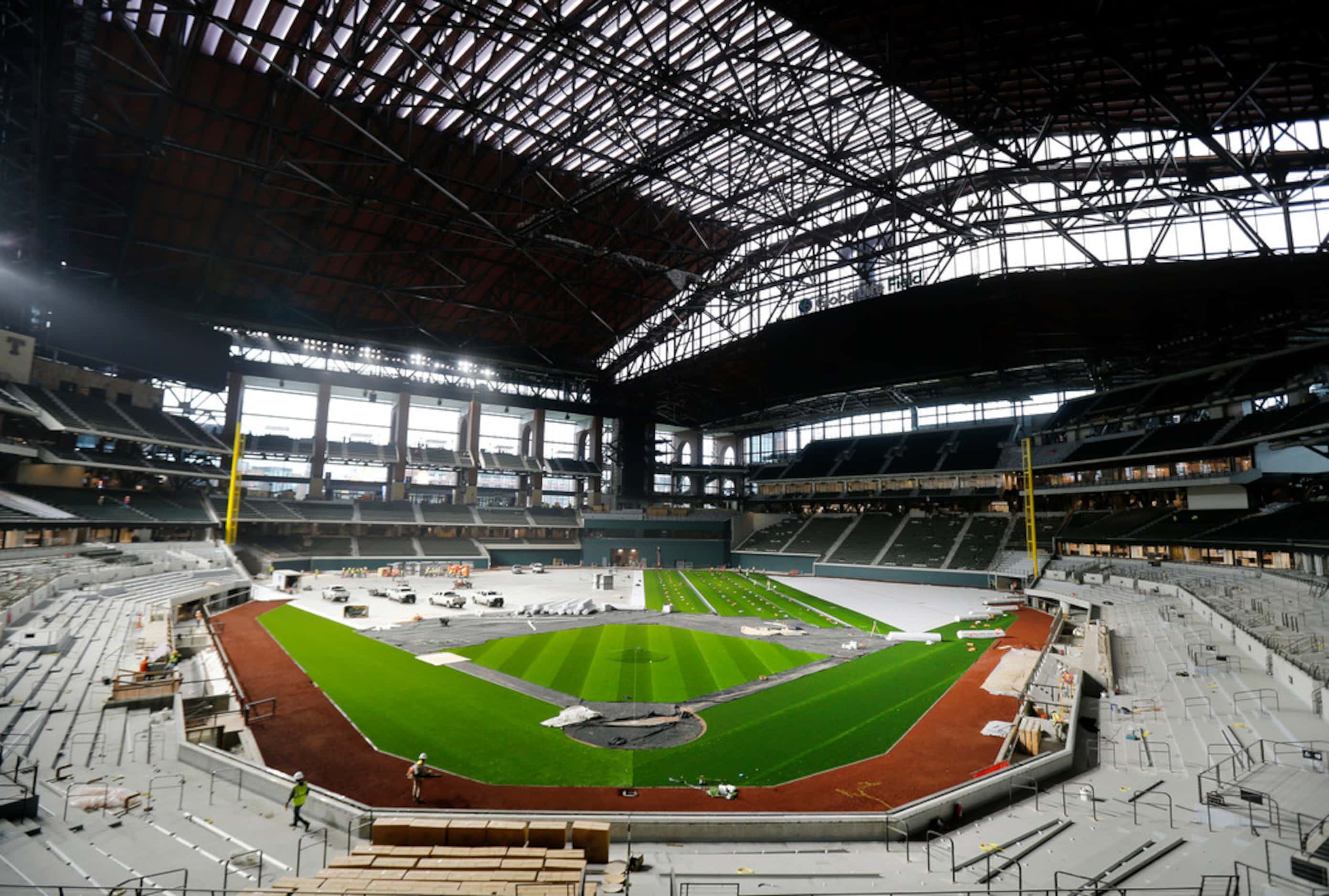 The artificial turf by Shaw Sports Turf and infield dirt are being installed at Globe Life...