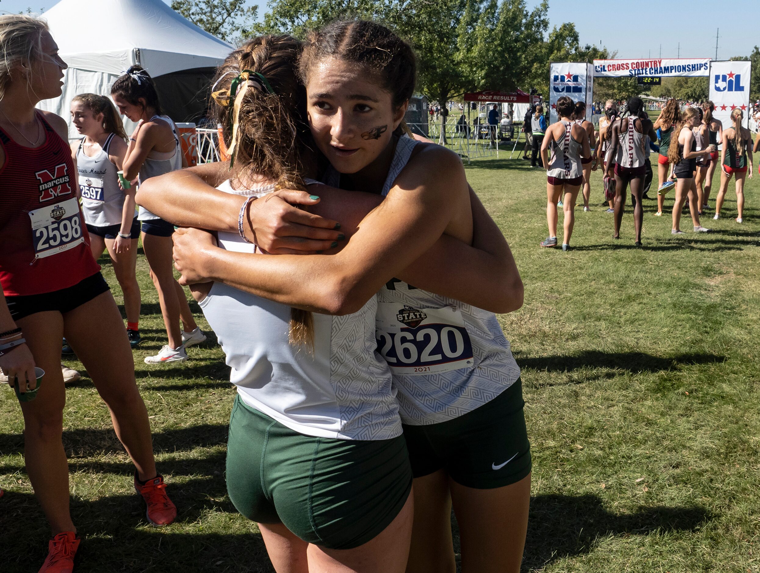 Prosper Taryn Stilson (2620) is hugged by teammate Emily Kern (2616) after crossing the...