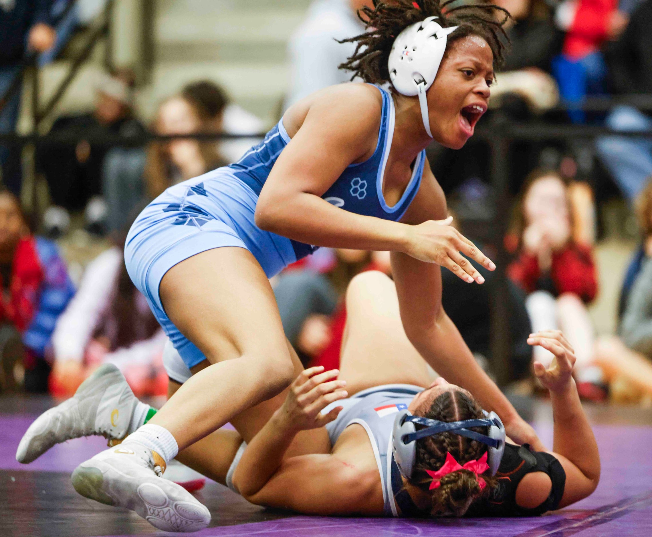 Summer Rodgers of Frisco Emerson cheer after defeating Mackenzee Bunton during 5A Region II...