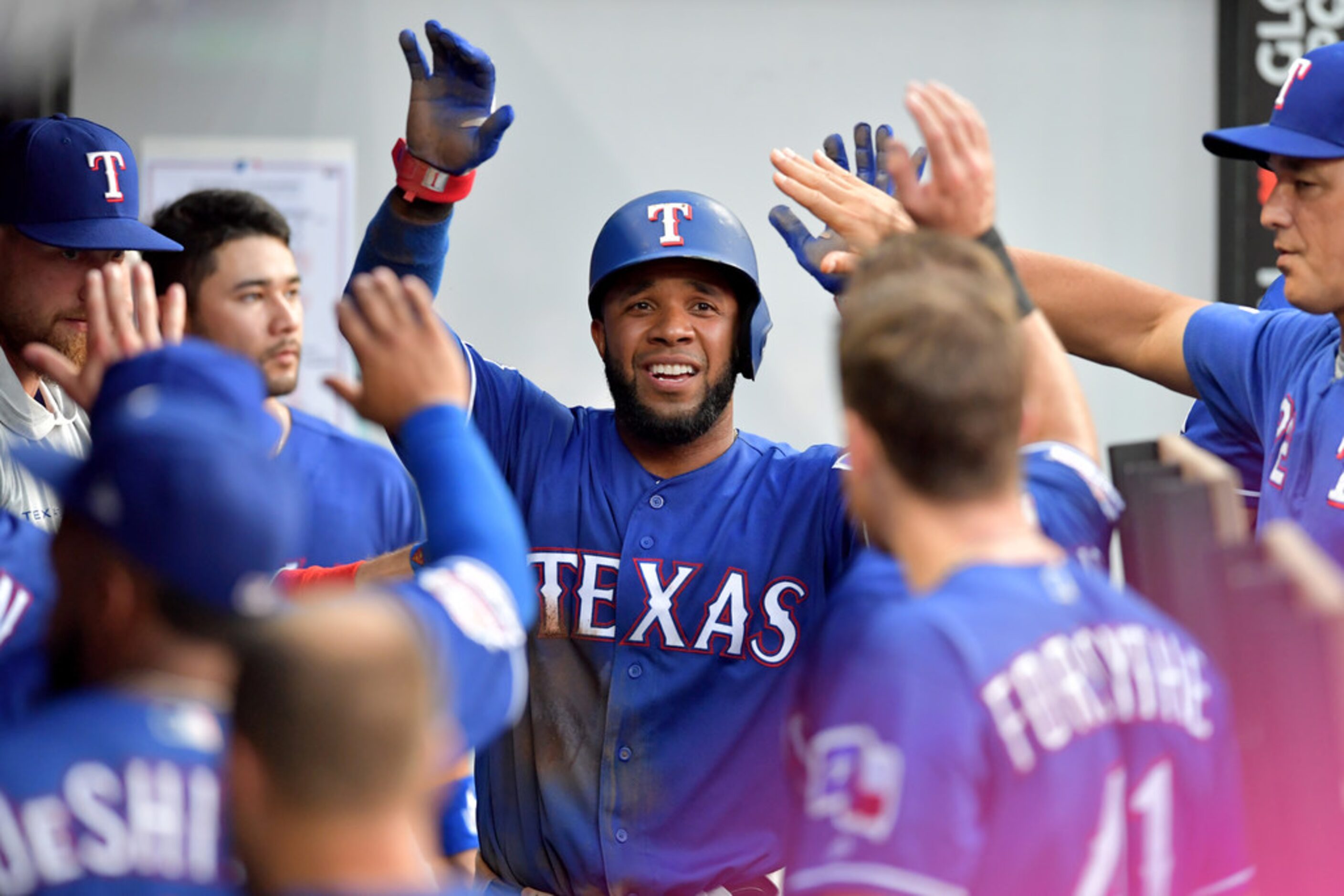 CLEVELAND, OHIO - AUGUST 05: Elvis Andrus #1 of the Texas Rangers celebrates after scoring...