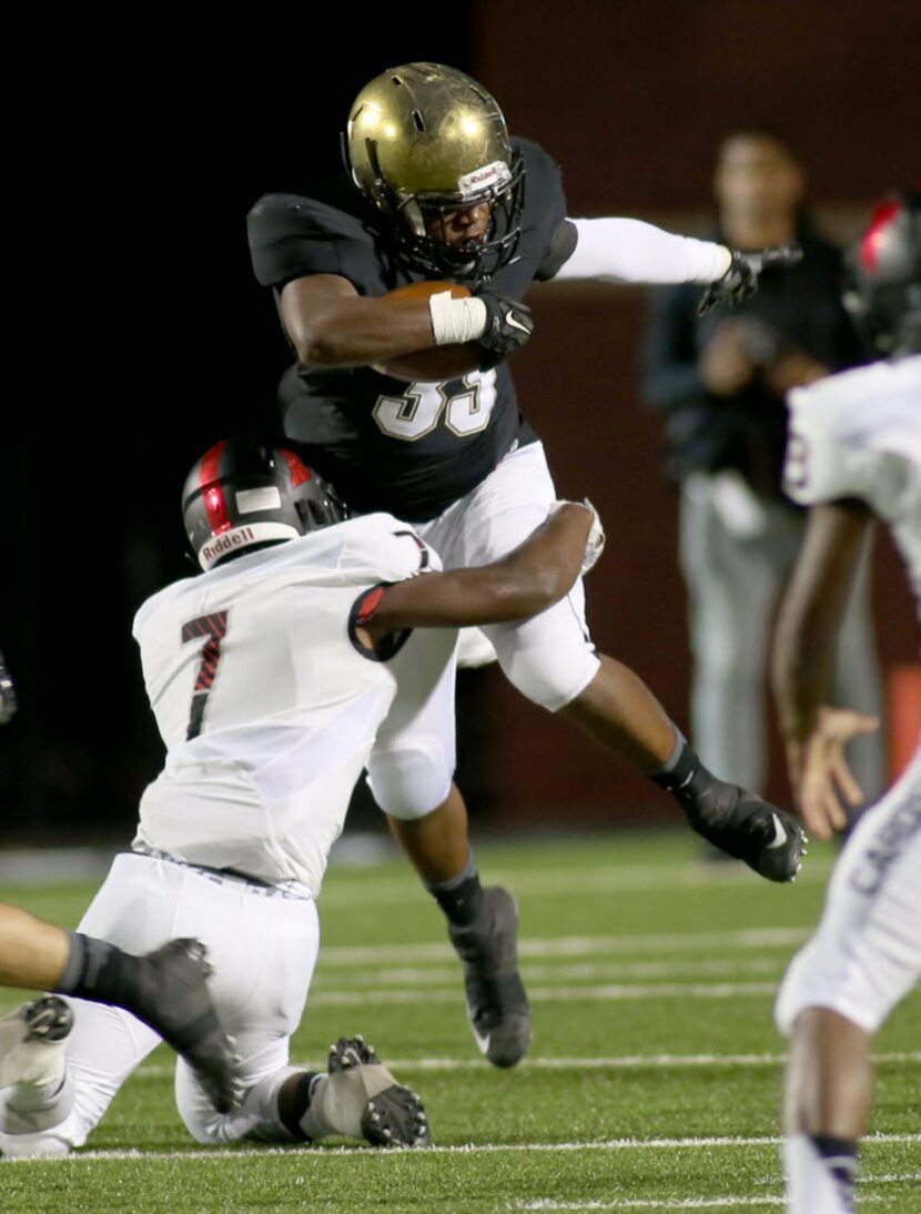 Irinvg’s James Miles, 35, is tackled by MacArthur’s Tony MacDonald,, 7, during game action...