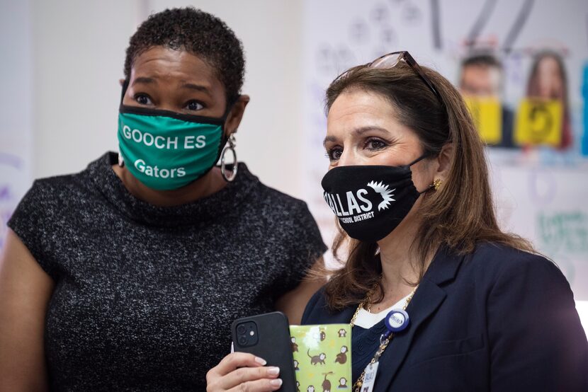 Susana Cordova (right), DISD deputy superintendent, speaks with Kermange Johnson, principal...