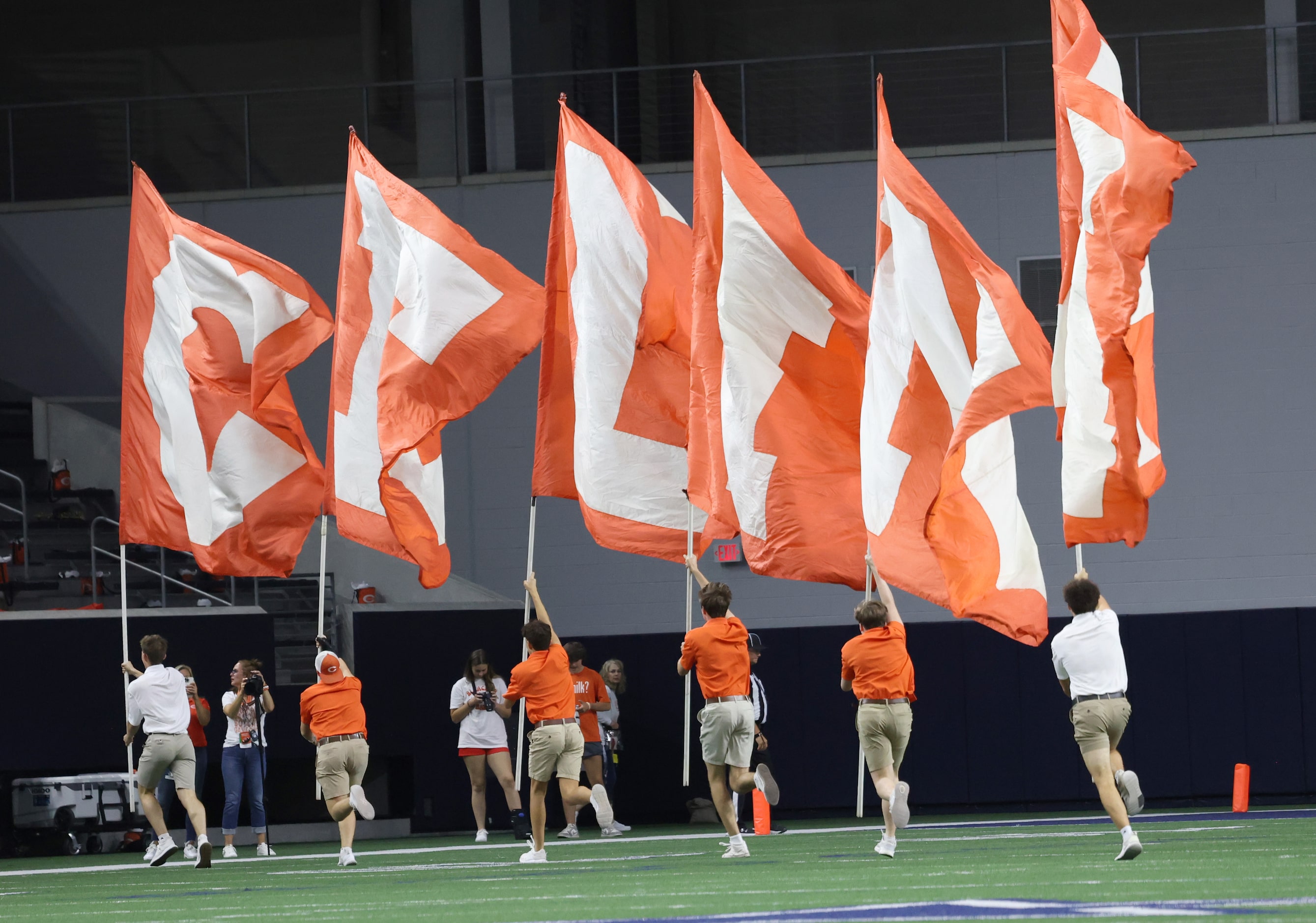 Celina students race across the field with the team spirit flags following a first half...