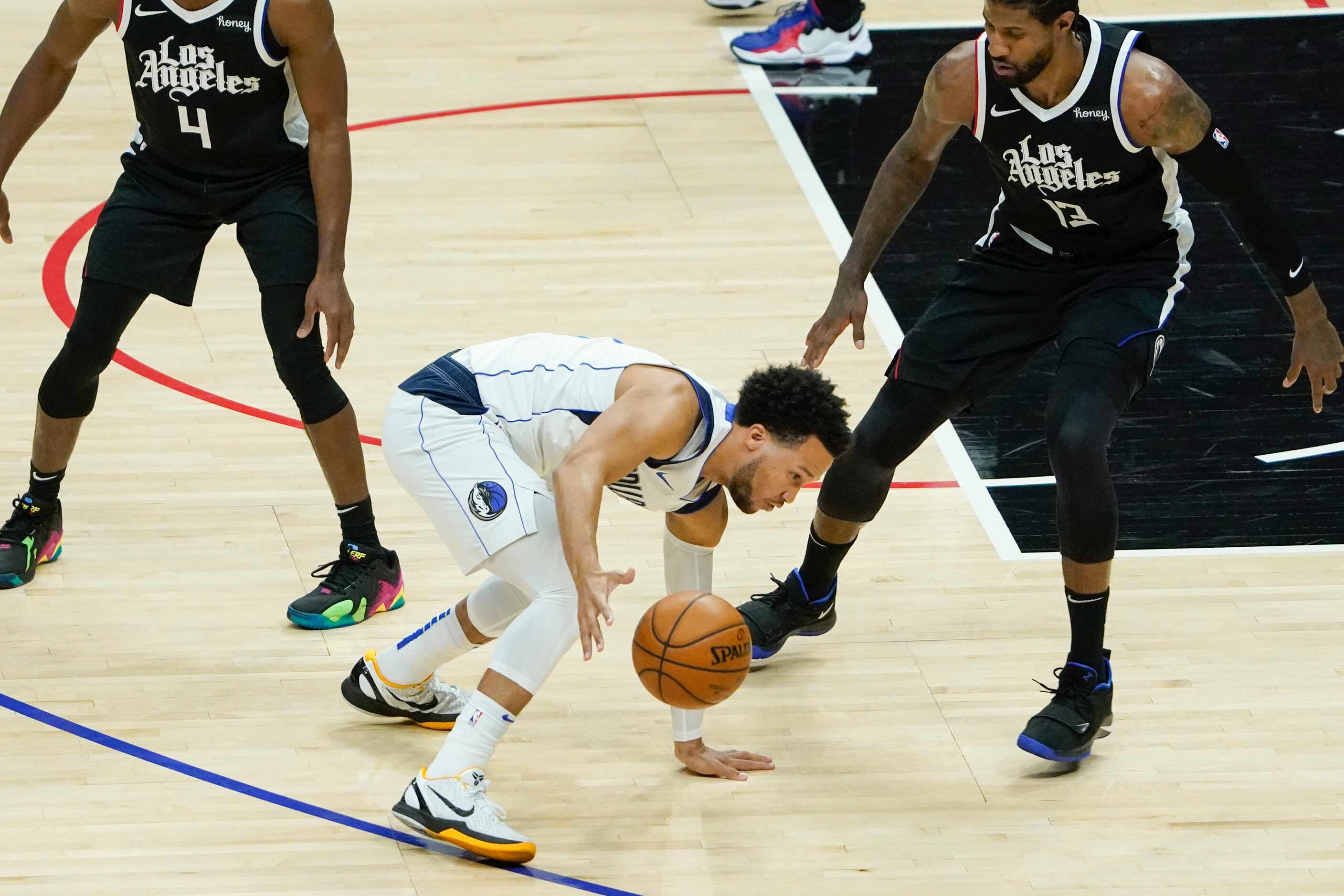 Dallas Mavericks guard Jalen Brunson (13) slips to the floor as he works against LA Clippers...