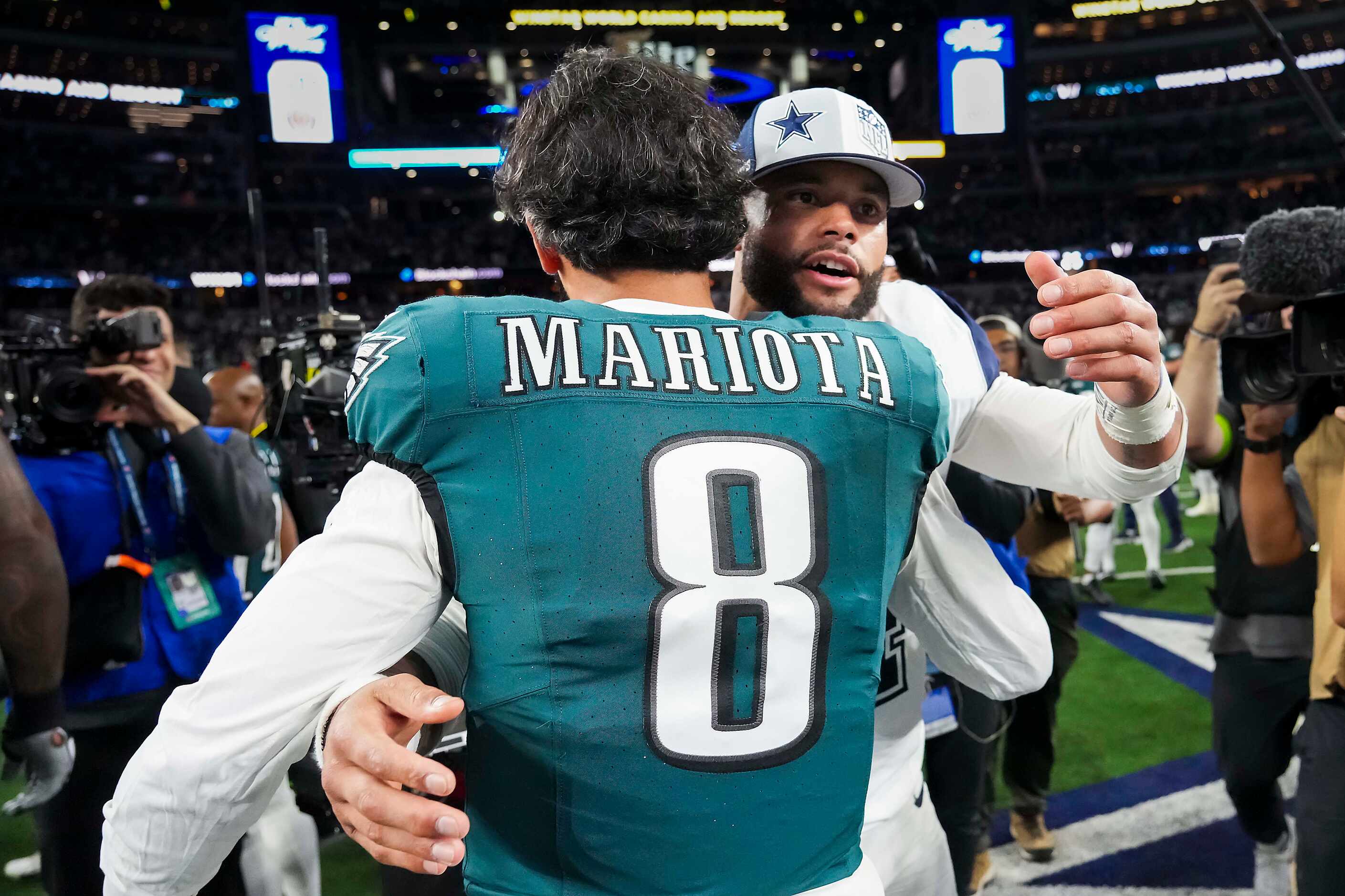 Dallas Cowboys quarterback Dak Prescott hugs Philadelphia Eagles quarterback Marcus Mariota...