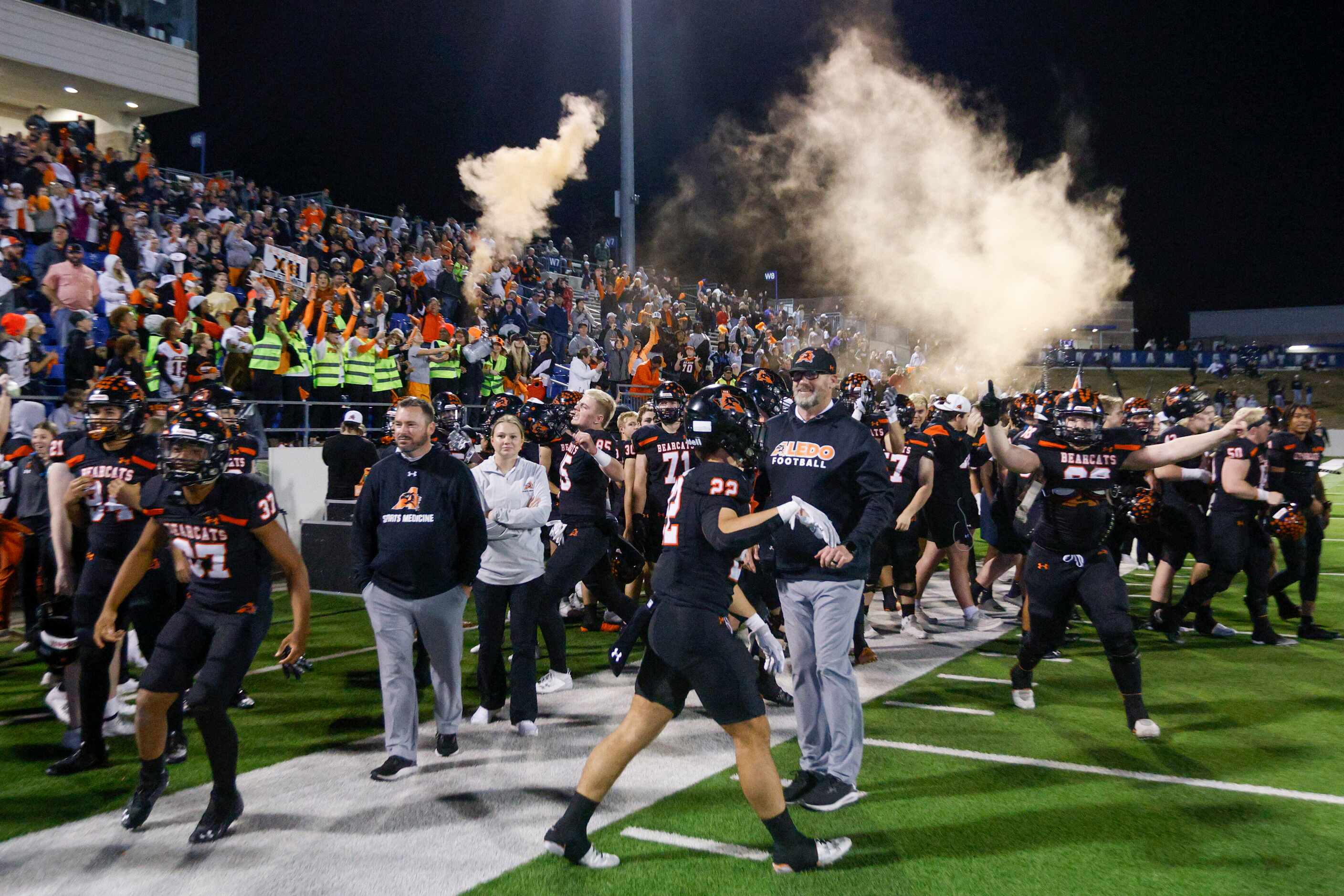 Aledo fans pop smoke and confetti after winning a Class 5A Division I state semifinal...