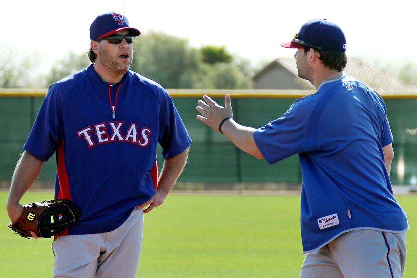 texas first basemen Lance Berkman, left, and Mitch Moreland discuss the intricacies of their...