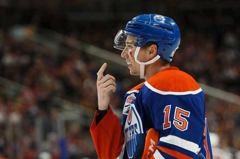 EDMONTON, AB - SEPTEMBER 26:  Tyler Pitlick #15 of the Edmonton Oilers points out a cut from...