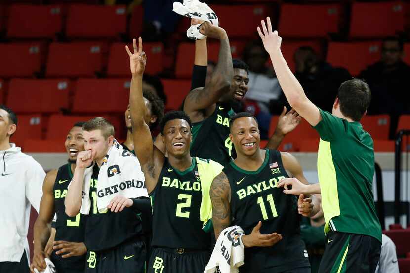 Baylor players cheer on the bench late in the second half of an NCAA college basketball game...