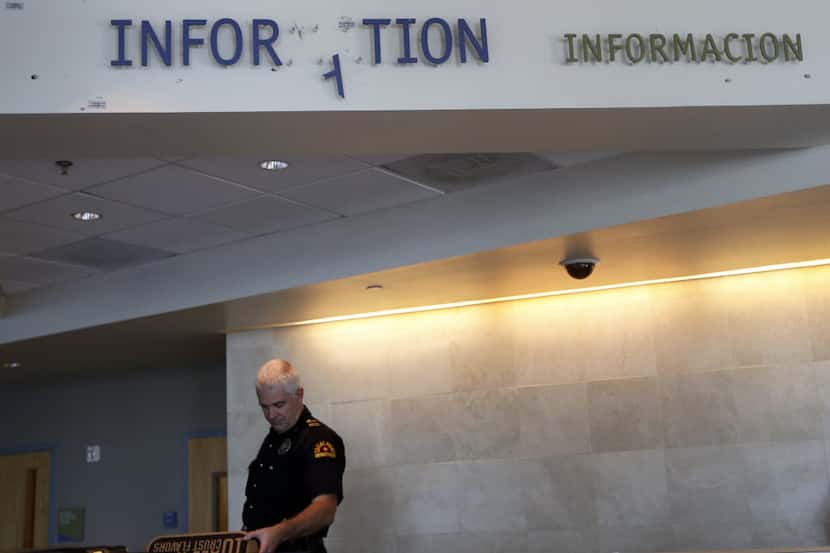  A sign hanging above the front desk of the Dallas Police Department's Jack Evans Police...