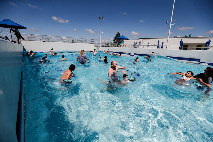 Swimmers ride the waves of Epic Waves, a 10,000 square-foot, 300,000 gallon wave pool, at...