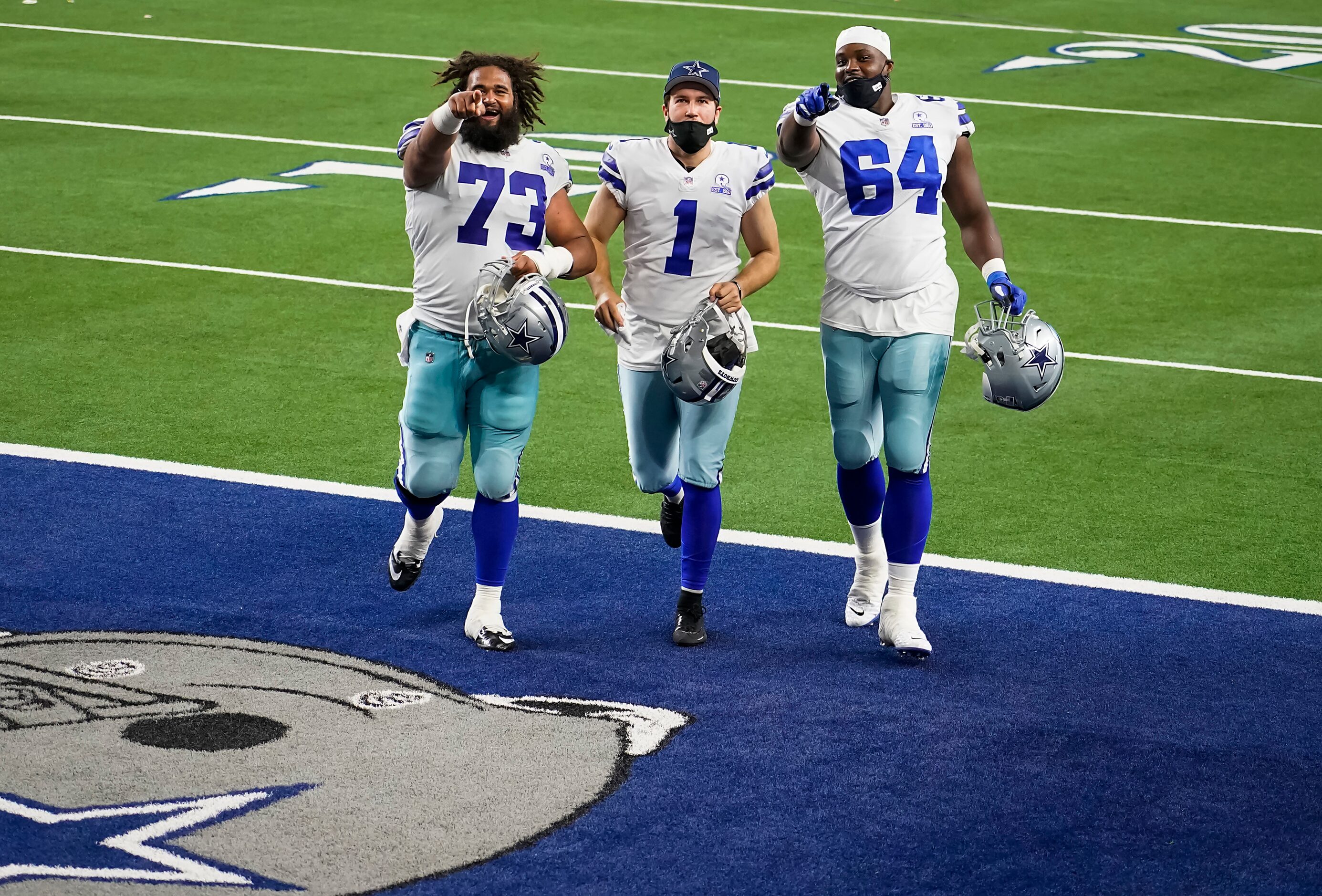 Dallas Cowboys center Joe Looney (73), punter Hunter Niswander (1) and offensive tackle Greg...