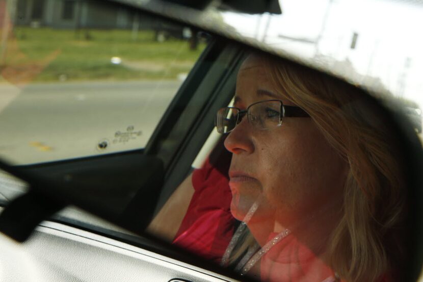 Tarrant County CPS child-abuse investigator Kelli Bailey drives to an appointment with a...