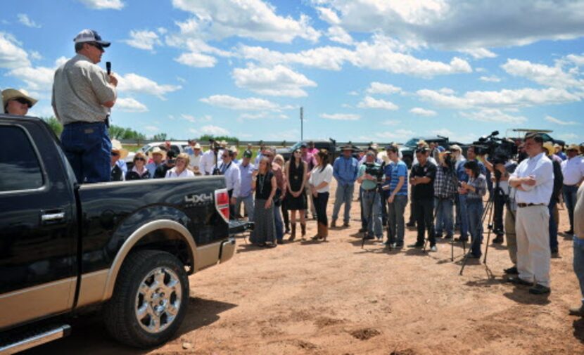  Clay County land owner Tommy Henderson, standing in pickup, addresses a group during a news...