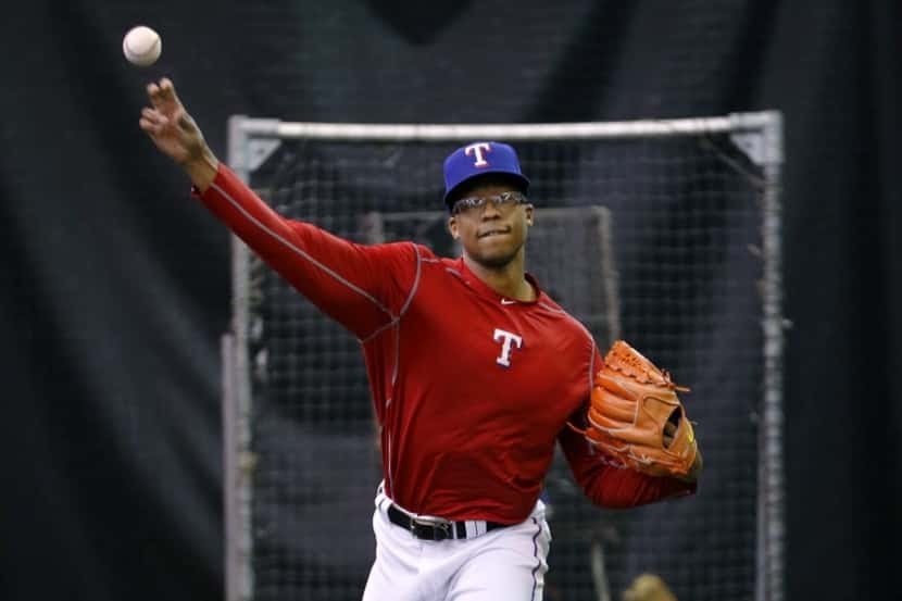 Pitcher Dillon Tate throws in their indoor workout area  of Globe Life Park in Arlington...