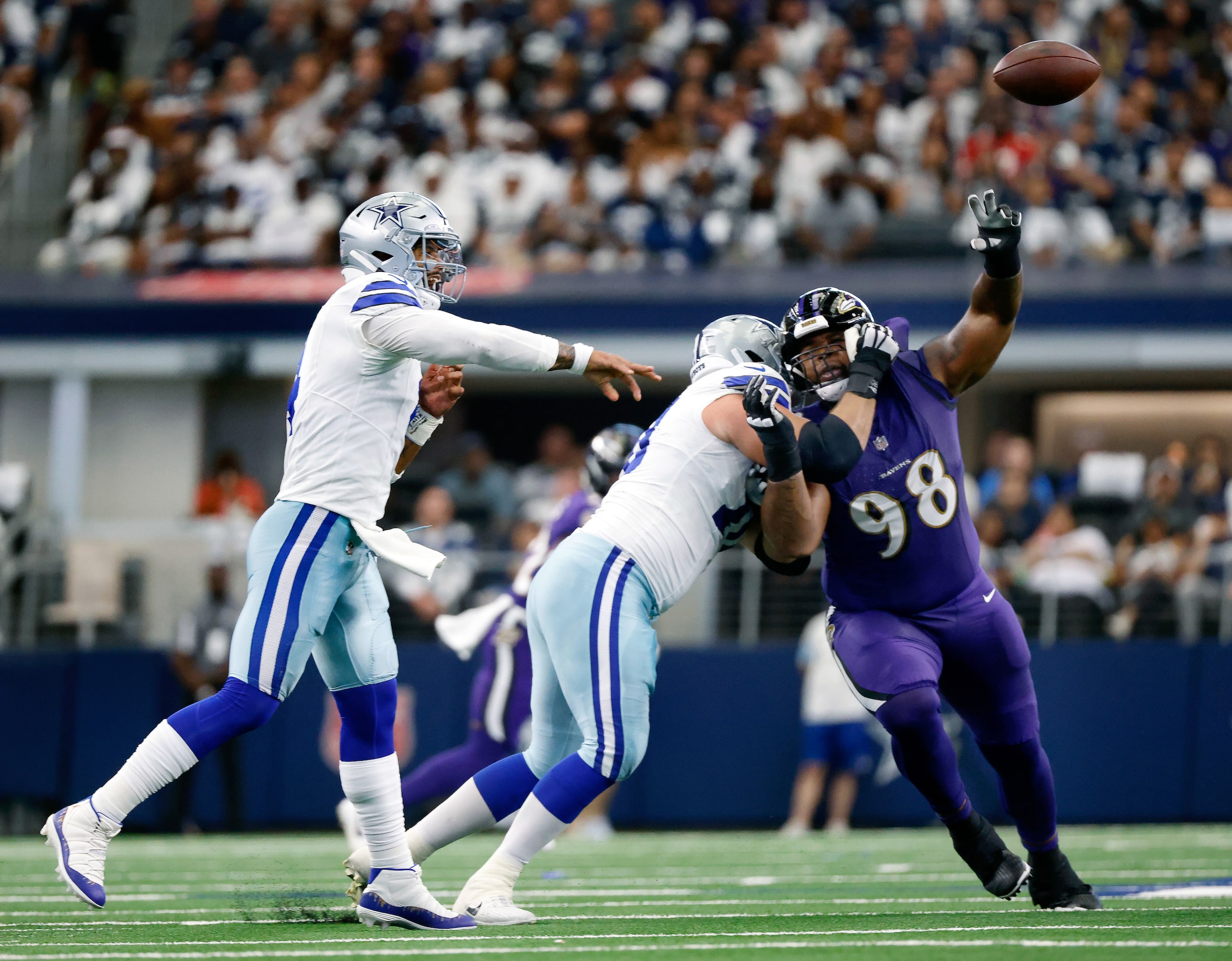 Dallas Cowboys quarterback Dak Prescott (4) gets off a clean throw as he receives a block...