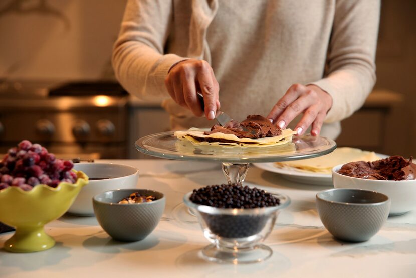 Kristen Massad prepares the layers for Chocolate Hazelnut Crepe Cake.