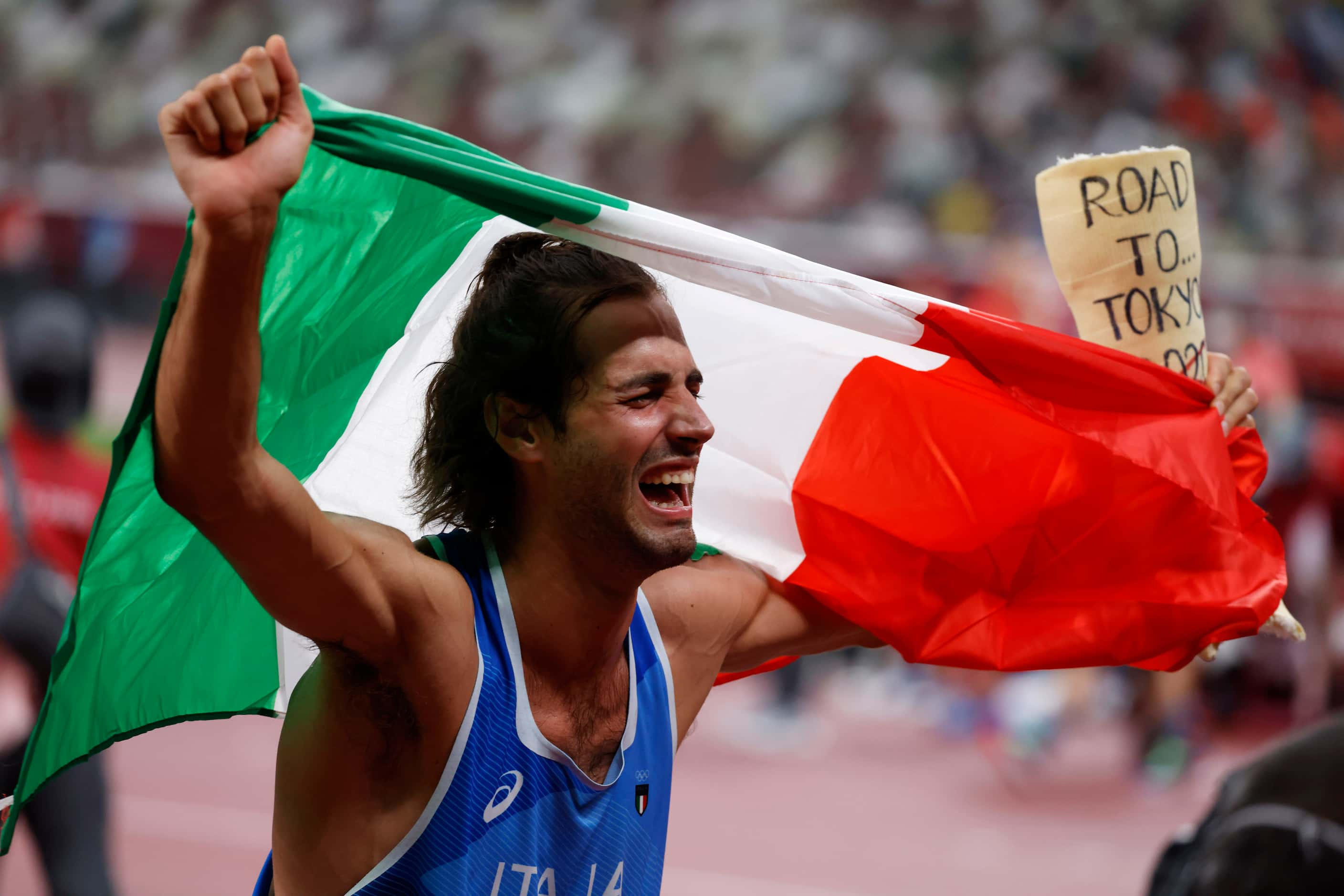 Italy’s Gianmarco Tamberi celebrates after winning a gold medal in the men’s high jump final...