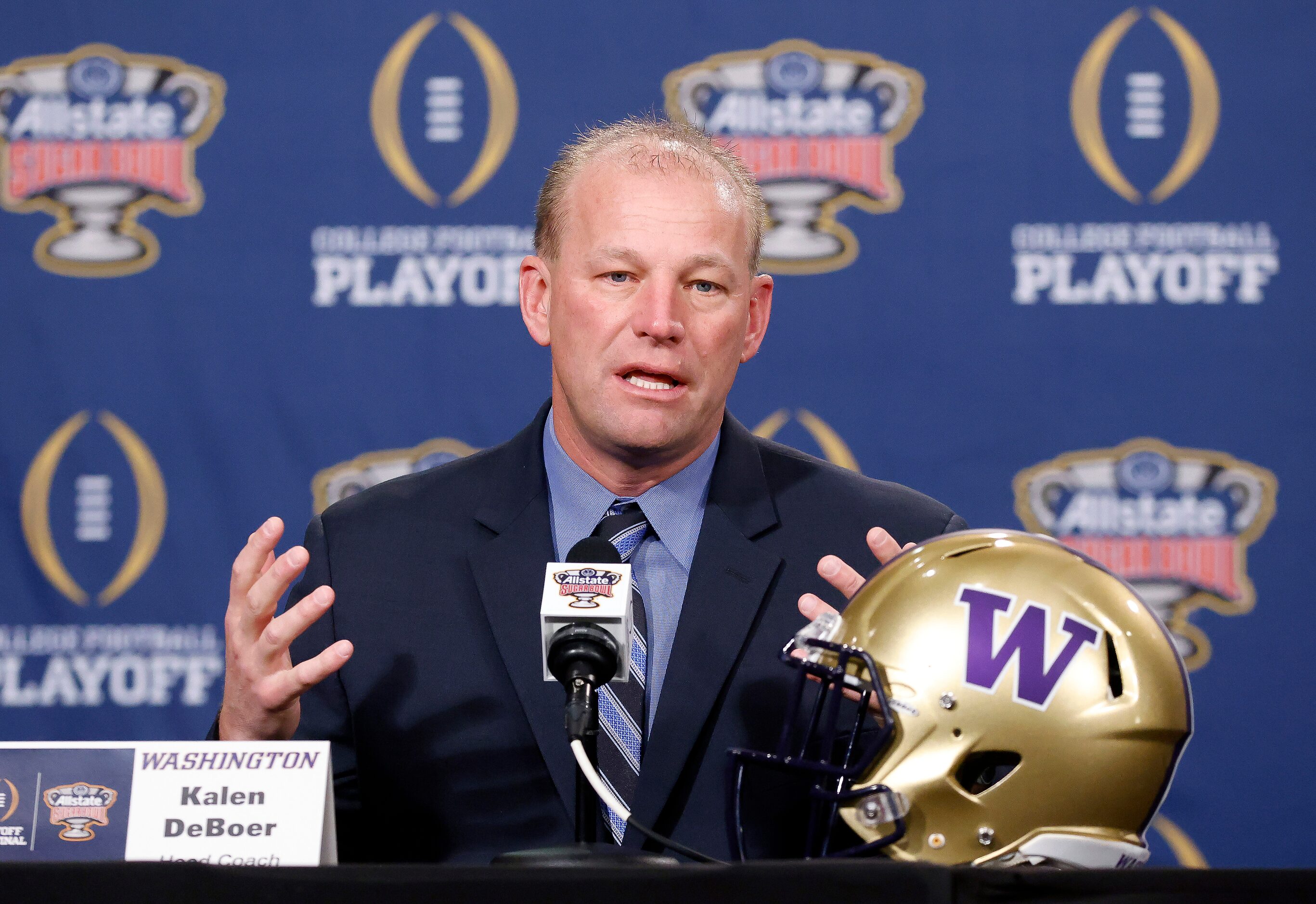 Washington head coach Kalen DeBoer answers questions from the media pose during his joint...