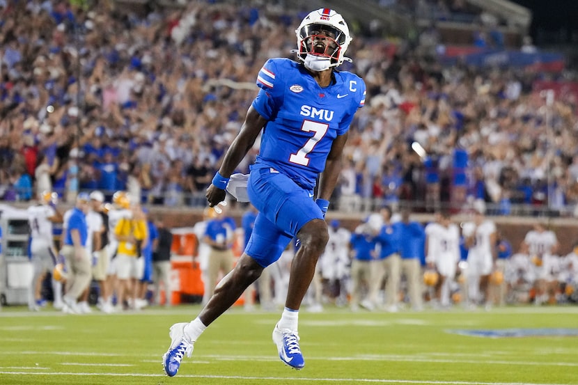 SMU quarterback Kevin Jennings (7) celebrates after throwing a touchdown pass to running...