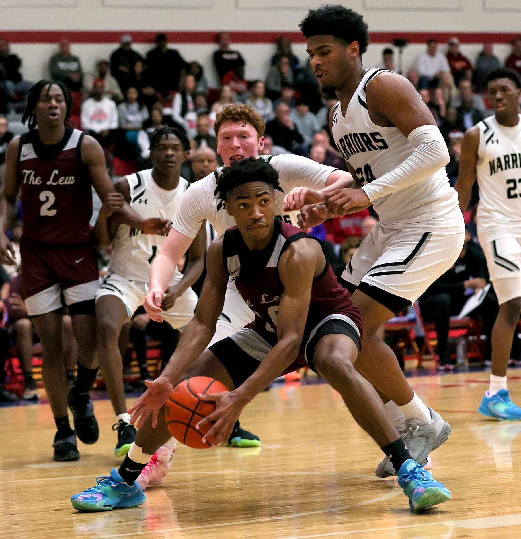 Lewisville guard Princeton Green, (center) gets trapped by Arlington Martin guard Ismael...