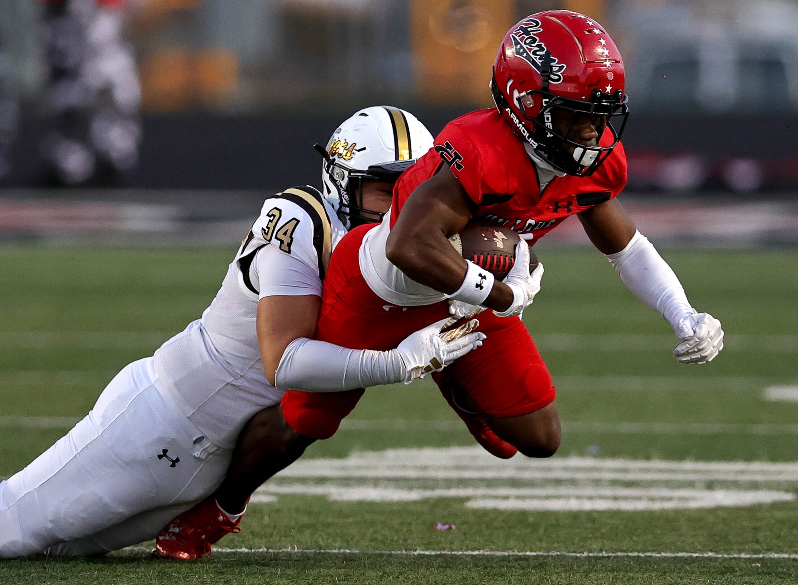 Cedar Hill wide receiver Keione Bright (right) comes up with a reception and is brought down...