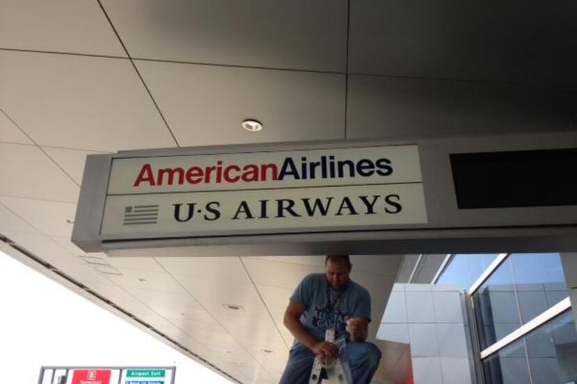A worker installed a new sign at John F. Kennedy International Airport’s Terminal 8 in...