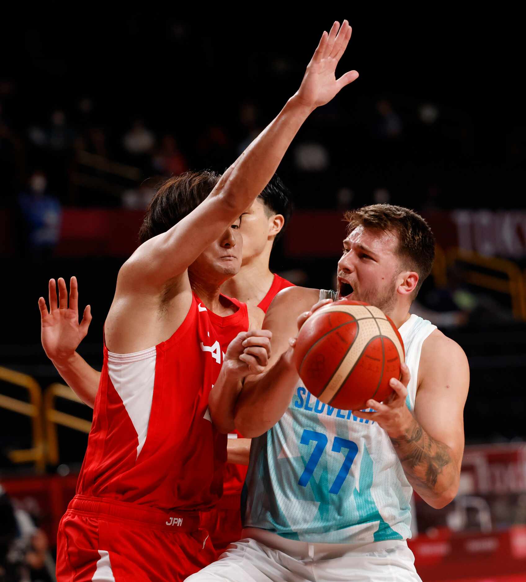 Slovenia’s Luka Doncic (77) draws a foul from Japan’s Daiki Tanaka (24) on a play in a...