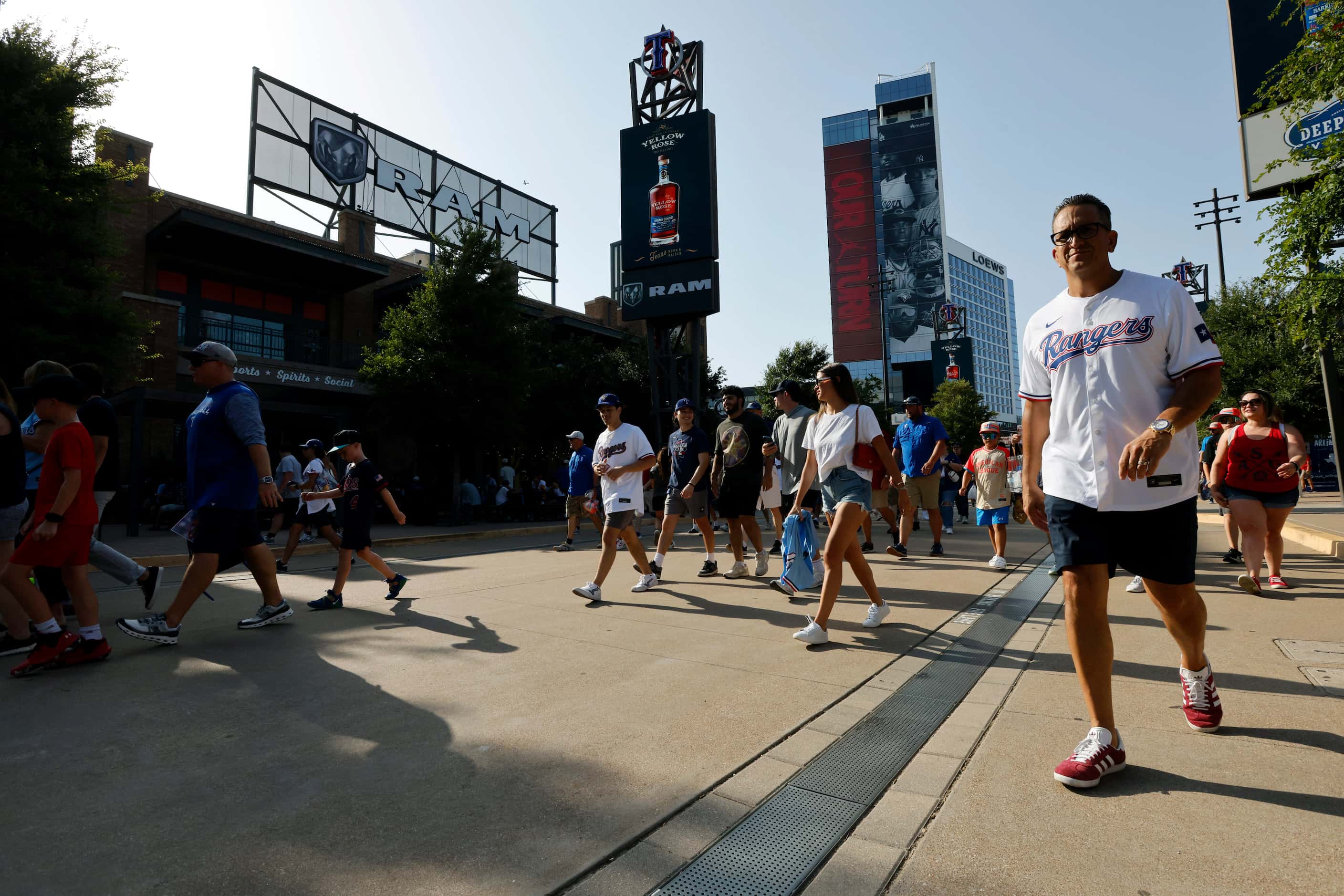 Fans make their way into Globe Life Field past Texas Live before the MLB Home Run Derby,...