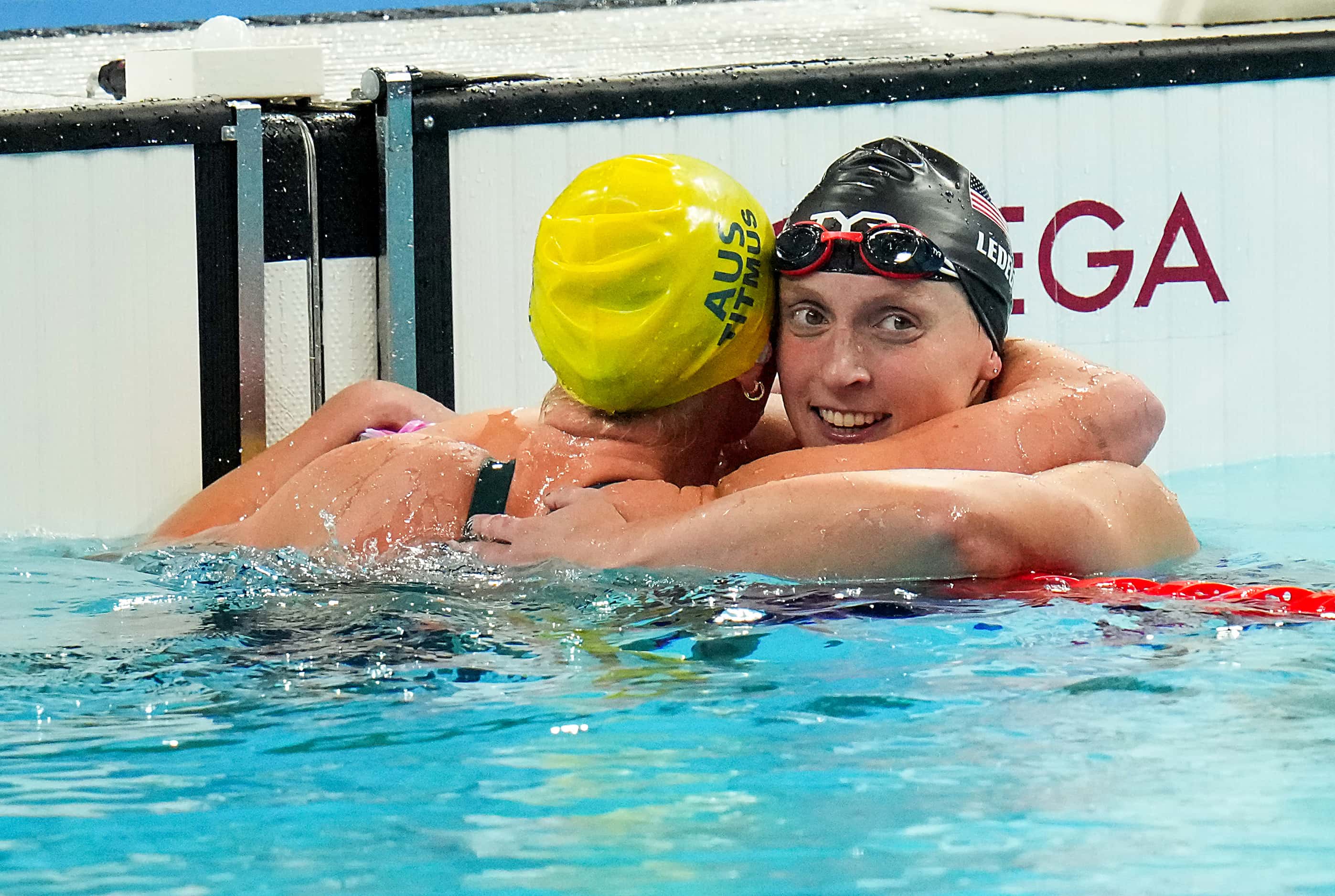 Bronze medalist Katie Ledecky (facing) congratulates gold medalist Ariarne Titmus of...