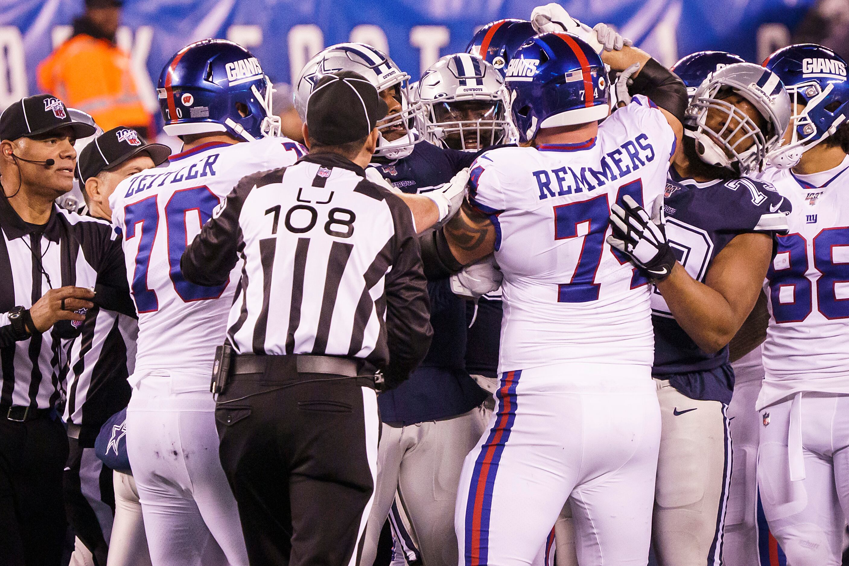 Officials try to separate scuffling players, including New York Giants offensive guard Kevin...