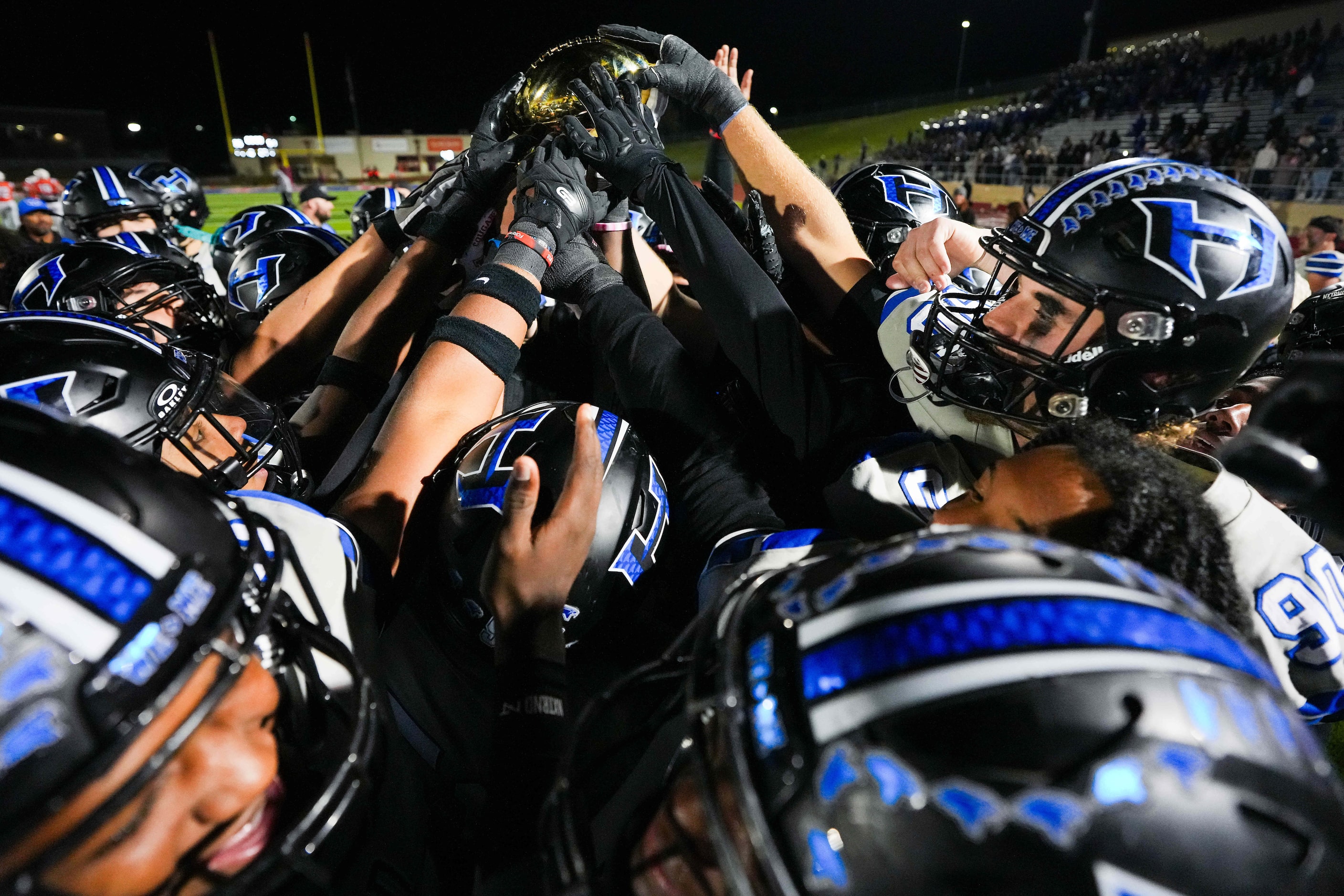 Hebron players, including defensive lineman Hudson Hill (90), celebrate with the Class 6A...