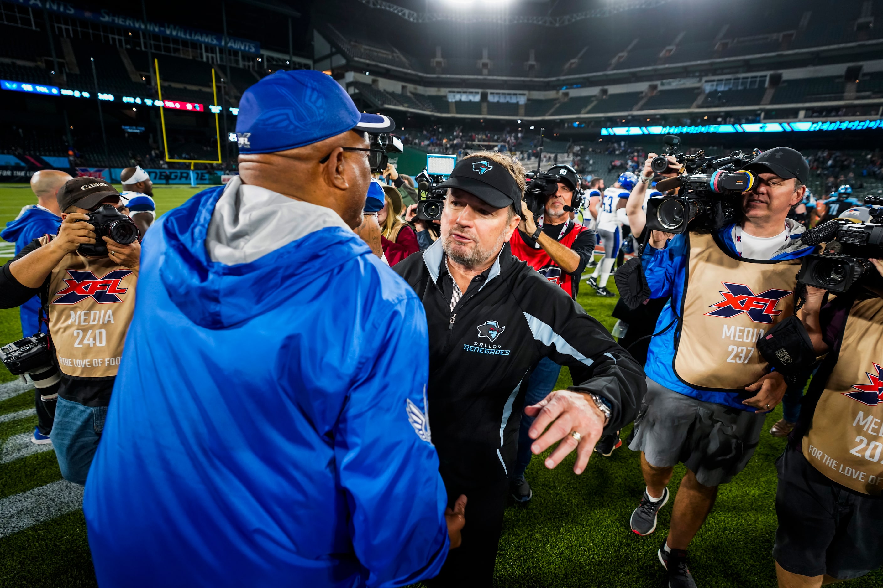 Dallas Renegades head coach Bob Stoops hugs St. Louis Battlehawks head coach Jonathan Haynes...