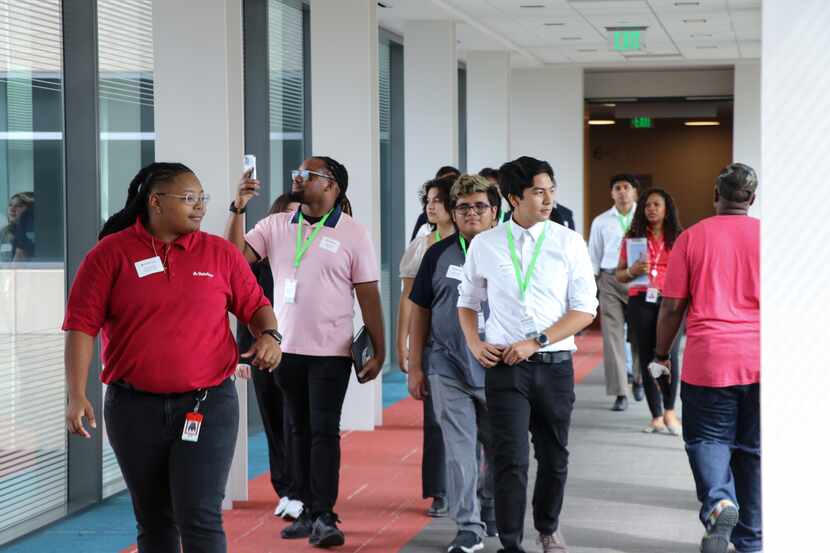 Students walk through glass-enclosed hallway at State Farm Cityline in Richardson.