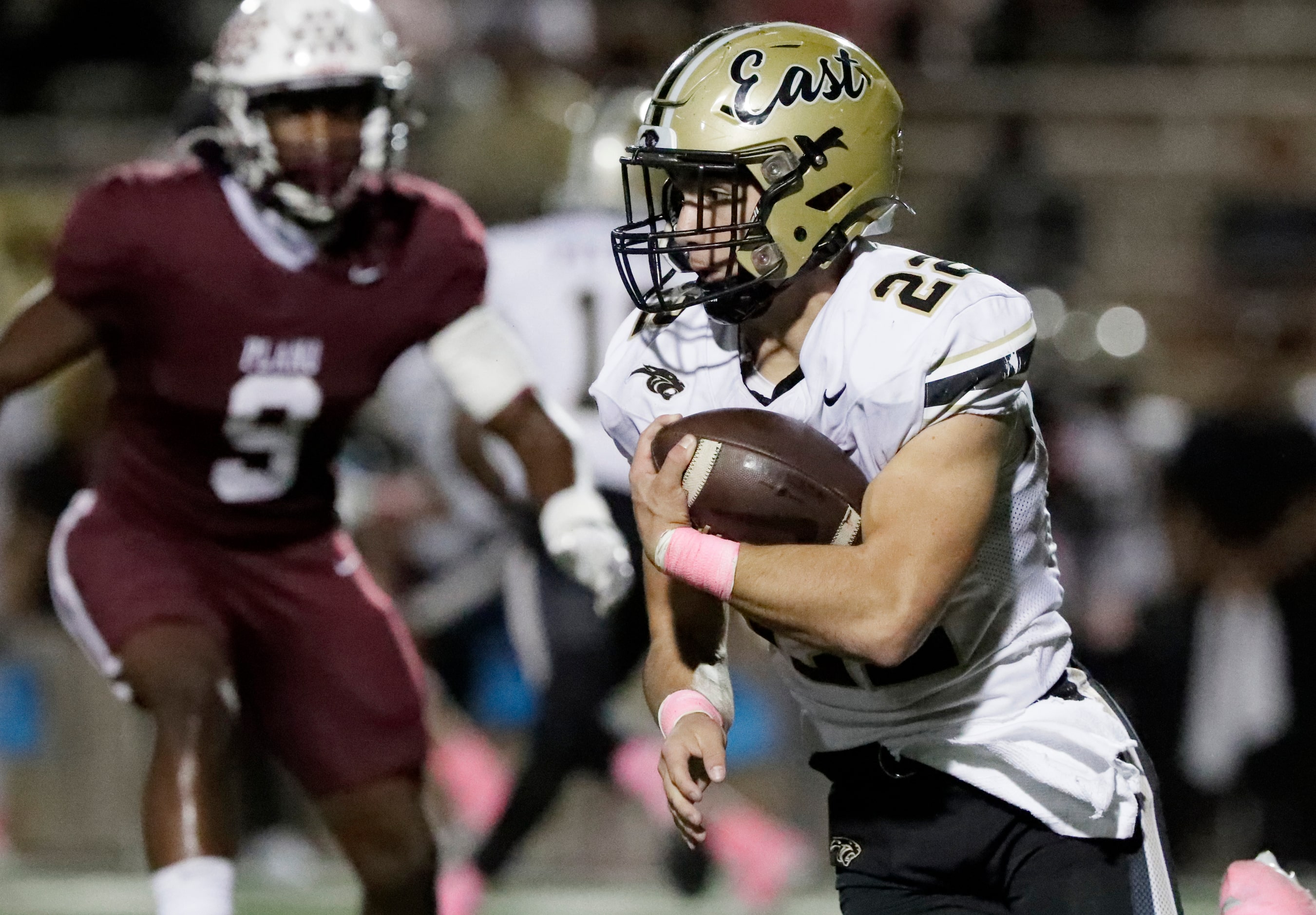 Plano East High School running back Travis Agee (22) runs for extra yardage during the first...