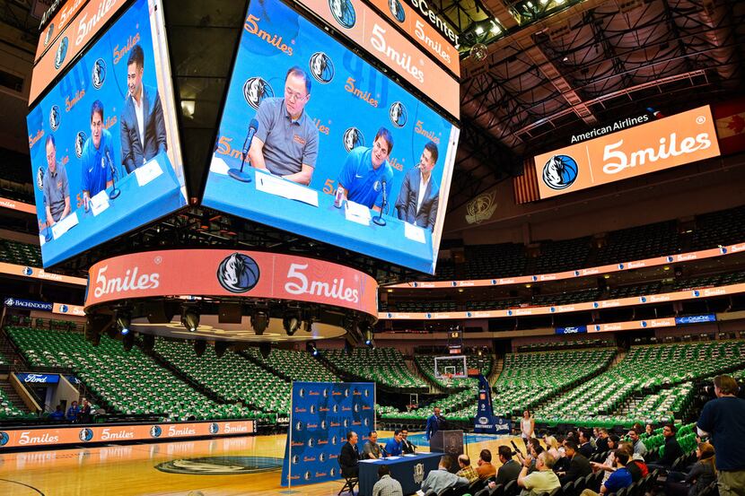 Dallas Mavericks owner Mark Cuban, center-on screen, announces a marketing partnership with...