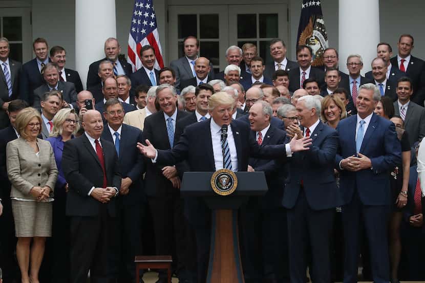 President Donald Trump speaks while flanked by House Republicans after they passed...