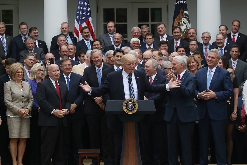 President Donald Trump speaks while flanked by House Republicans after they passed...