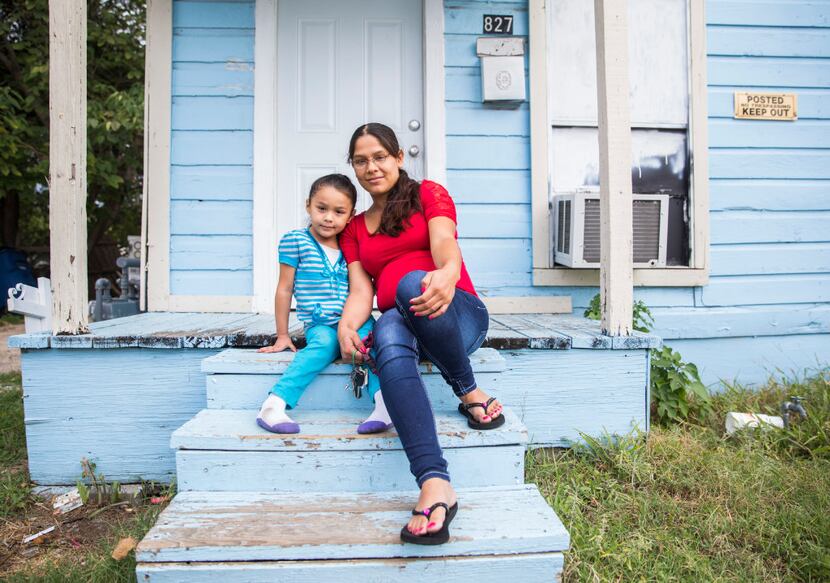 Joanna Pena and daughter Zaory Rendon, 4, sit on the stoop of their West Dallas home, which...