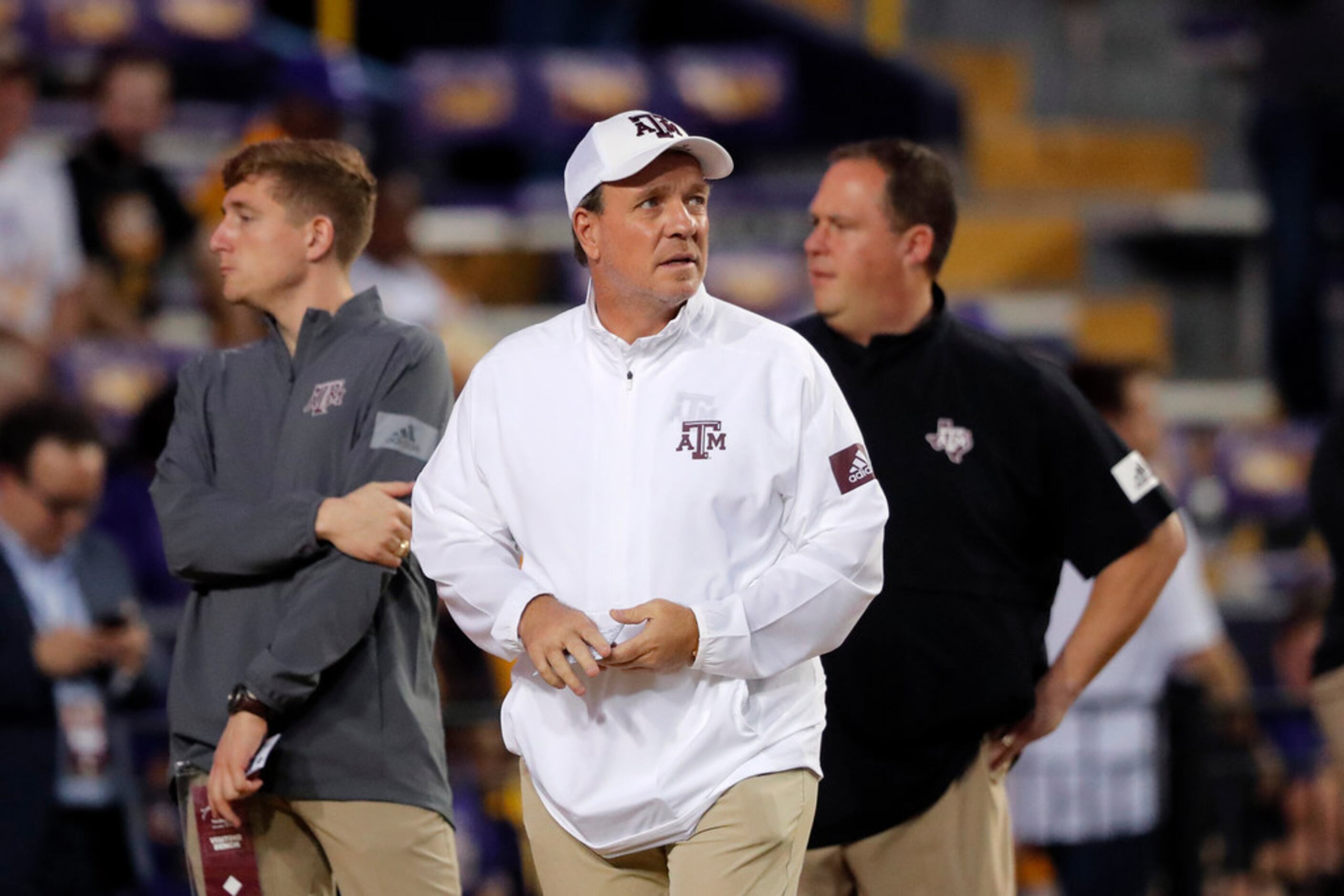Texas A&M head coach Jimbo Fisher walks on the field before an NCAA college football game...
