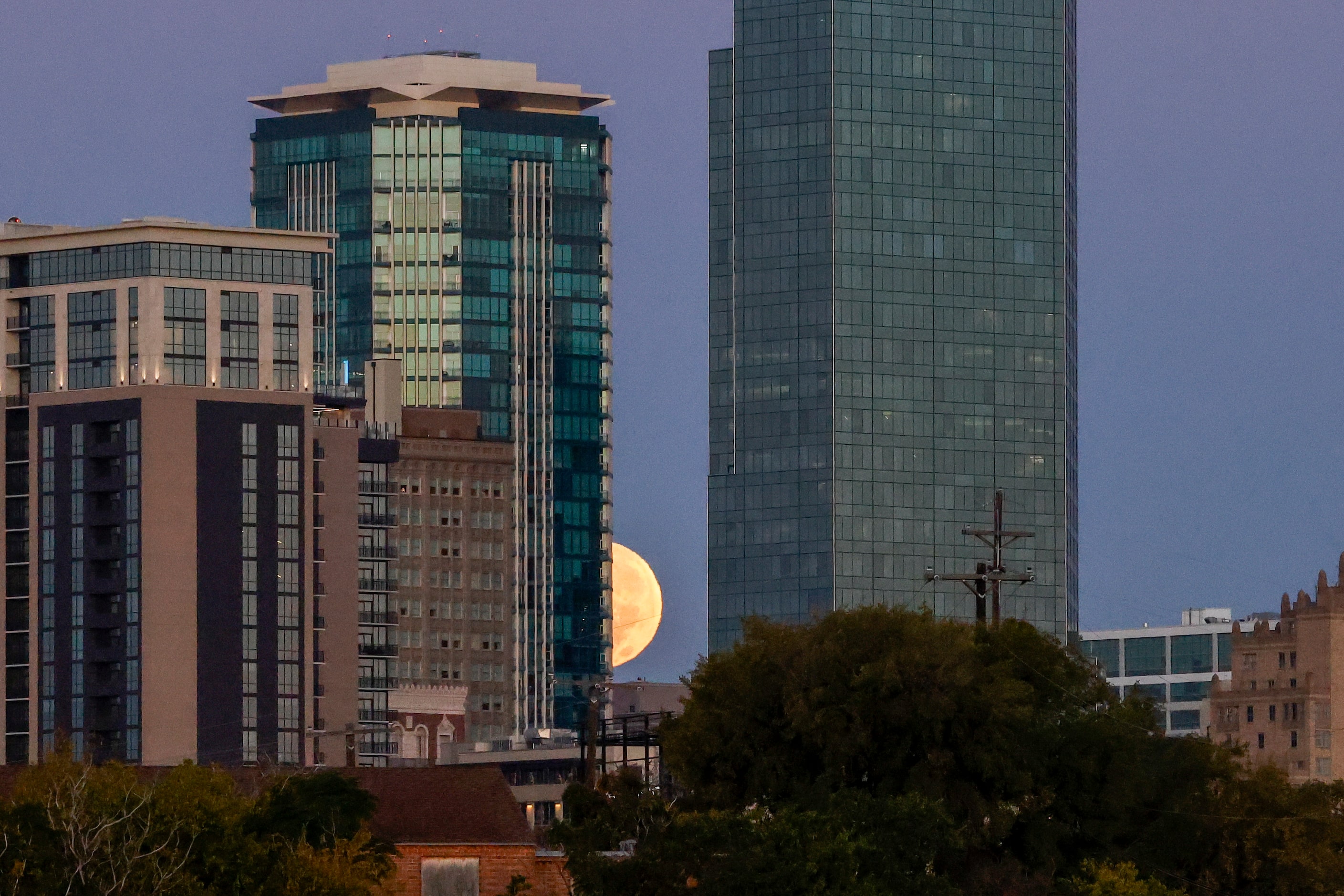 A supermoon sets behind downtown Fort Worth, Thursday, Oct. 17, 2024. A supermoon is a full...