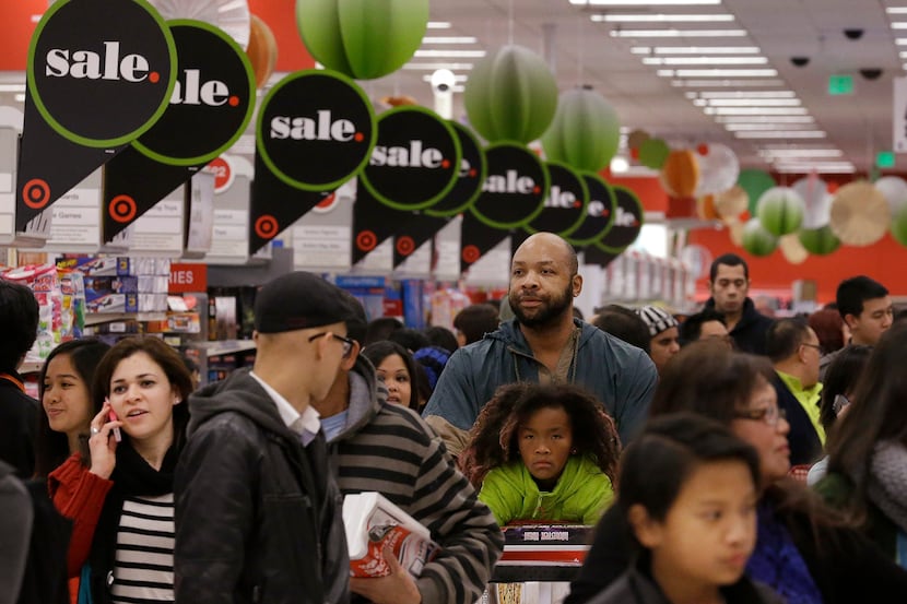 People shop at a Target store in Colma, Calif., Thursday, Nov. 28, 2013. Instead of waiting...