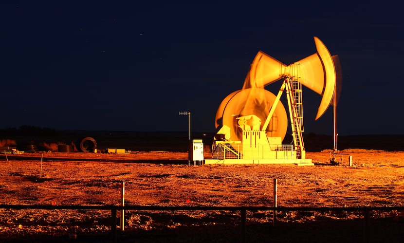 An oil pump jack stands outside of Watford City, N.D.
