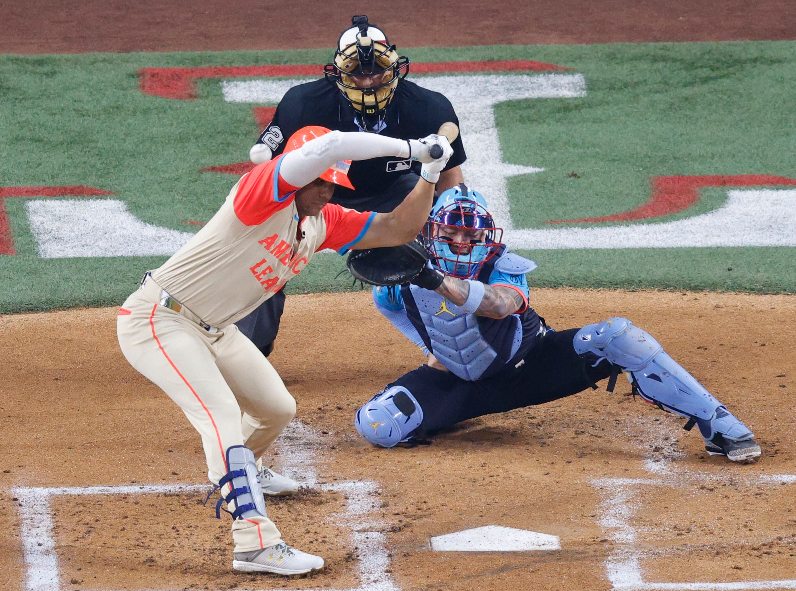 American League outfielder Juan Soto of New York Yankees is hit by a ball during the first...