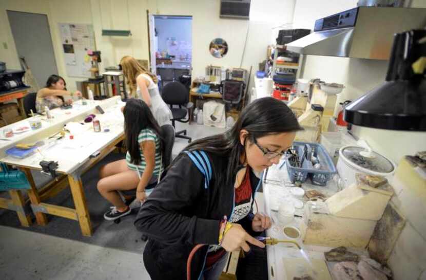 
Valerie Martinez uses a small torch on a project in her jewelry-making class.

