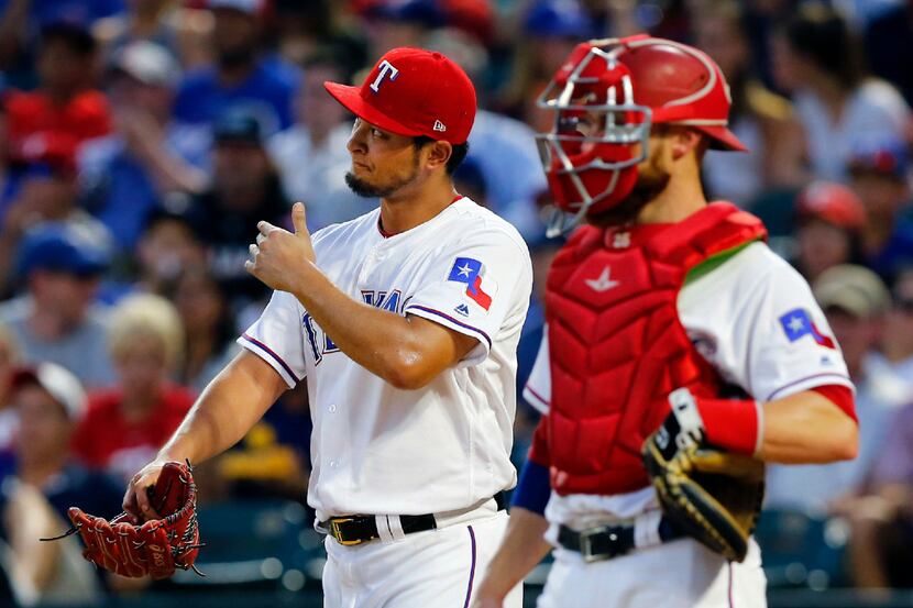 Texas Rangers starting pitcher Yu Darvish (left) reacts after Miami Marlins Marcell Ozuna's...